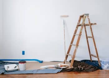 DIY paint set up inside a home, with a white wall.